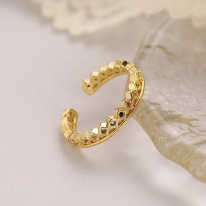 Macro shot of gold plated adjustable ring with colorful zircon in rhombus pattern