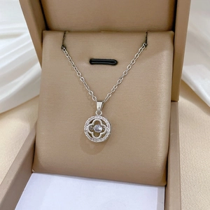 Detailed view of lucky clover necklace with sparkling crystals in a jewelry box