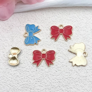 Detailed front and back view of pink and red enamel bow pendants for jewelry making