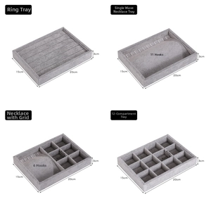 Macro detail of grey velvet jewelry display tray options with various organizer grids