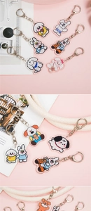 Detail of cute acrylic cartoon rabbit and puppy keychains with metal D-ring clips