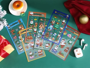 Close-up of waterproof Christmas PET stickers with cartoon Santa and reindeer motifs