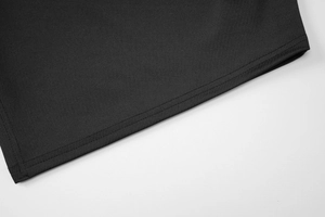 Close-up of double-needle stitching and knit texture on black slim-fit T-shirt hem