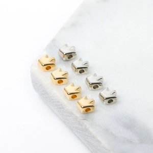 Detailed view of crown-shaped gold and silver CCB beads for DIY jewelry making