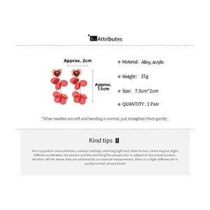 Detail view of red acrylic petal tassel earrings with heart stud and size dimensions