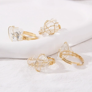 Detailed view of handmade gold wire wrapped rings with natural clear quartz crystals