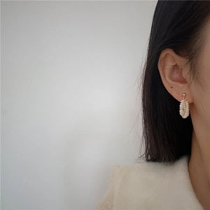 Close-up of elegant baroque freshwater pearl cluster earrings on a model's side profile