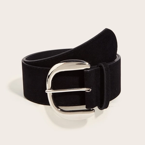 Detail of a vintage black suede wide belt featuring a large silver metallic buckle