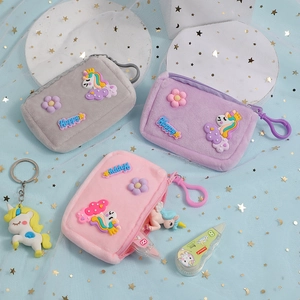 Three plush unicorn coin purses in grey, purple and pink with golden star hooks