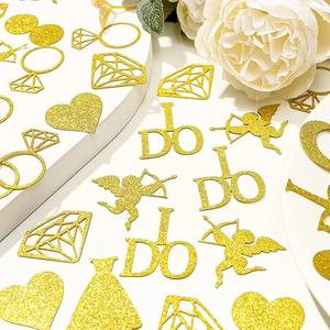 Golden glitter confetti set with heart, diamond, and ring shapes for wedding table decor
