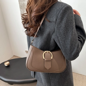 Retro brown litchi pattern crossbody bag with golden buckle shown on a model