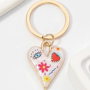 Porte-clés cœur pop art avec œil bleu et motifs floraux sur un anneau en alliage doré