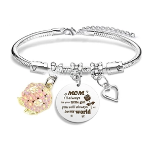 Detail of silver snake chain bracelet with floral, heart and MOM engraved charms