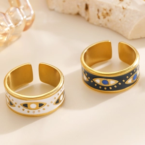 Close-up of golden evil eye rings with blue pupil and adjustable opening detail