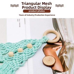 Detail of mint green macrame Christmas tree wall hanging with wooden beads and ring