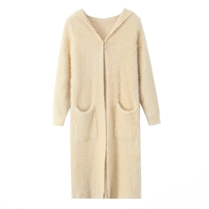 Detail of beige mohair hooded cardigan showing thick plush texture and large front pockets