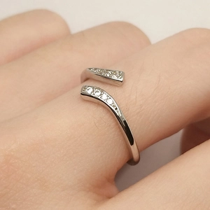 Silver open ring with cubic zirconia accents on adjustable metal band for women