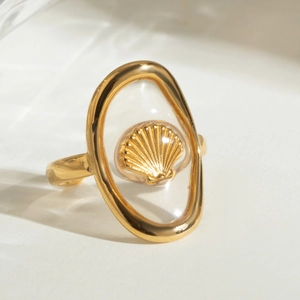 Close-up of 18k gold-plated ring featuring an oval resin inlay and shell engraving