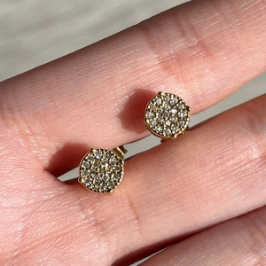 Macro view of gold plated hip hop stud earrings with micro paved white zircon stones