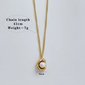 Detail showing gold chain necklace with irregular pearl pendant and sizing dimensions