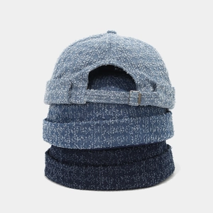 Detail of washed denim dockers caps with adjustable metal buckles in three blue shades