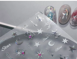 Close-up of 5D silver star and moon nail art stickers with metallic laser texture