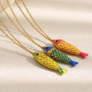 Detail of colorful enamel fish pendants on 18K gold plated stainless steel necklaces