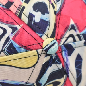 Detailed top view showing the six-panel crown construction and fabric button of the cap