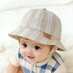 Striped baby sun hat in beige cotton with adjustable chin strap and leather label