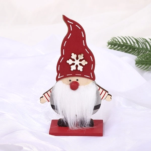 Handcrafted wooden Christmas gnome ornament with red snowflake hat on festive background
