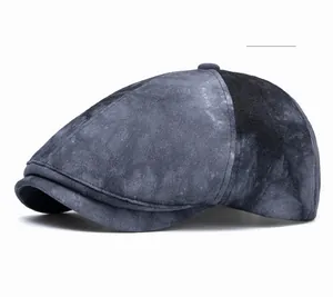 Detail of vintage washed cotton newsboy cap featuring black marble acid wash texture
