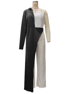 Detail of asymmetrical jumpsuit featuring silver sequins and black blazer style tailoring