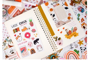Detail of bohemian stickers on a spiral notebook with colorful cartoon illustrations
