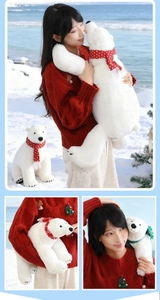 Detail of plush white polar bear toy featuring a festive red and green knitted scarf
