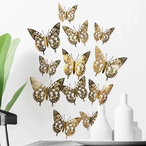 Detailed view of 12 hollow golden 3D paper butterflies on a minimalist white wall