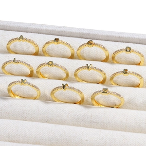 Adjustable 18k gold plated brass rings with diamond-set letters in a white display box