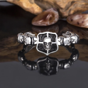 Macro view of punk skull bracelet with embossed shield and antique silver finish