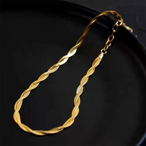 Elegant gold twisted braid titanium steel necklace on a premium matte black jewelry tray