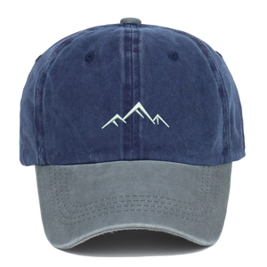 Detailed close-up of mountain peak embroidery on washed cotton baseball cap