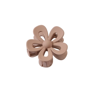 Detail of matte pink hollow flower claw clip showing frosted texture and spring mechanism