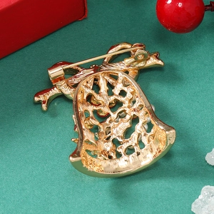 Macro detail of Christmas bell brooch back showing secure pin and gold alloy structure