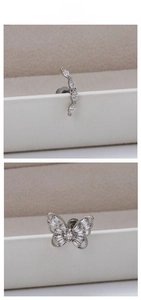 Detailed view of silver titanium steel earrings with zircon butterfly and curved studs