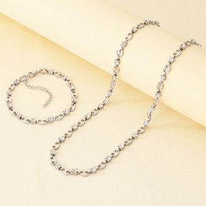 Detail of adjustable silver stainless steel jewelry set with claw-set cubic zirconia stones