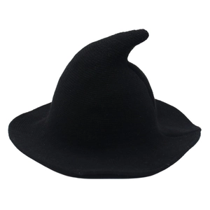 Close-up of black knitted wool blend witch hat with sharp pointed top and wide brim