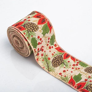 Macro detail of Merry Christmas linen ribbon with pine cones and holly berry pattern