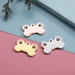 Three bone-shaped titanium steel pet pendants in rose gold, gold and silver with paw cutouts