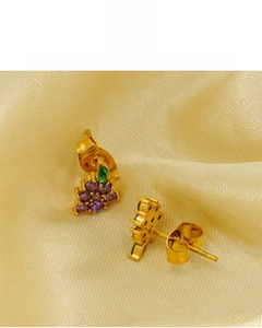 Detail of 18K gold plated grape stud earrings featuring purple and green crystals