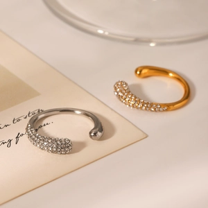 Close-up of minimalist gold and silver open ear cuffs with sparkling rhinestone inlay