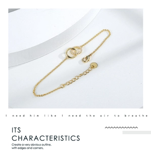Detail of gold double-circle bracelet featuring sparkling crystals and lobster clasp