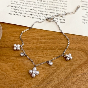 Macro detail of silver flower bracelet with pearls and sparkling cubic zirconia stones